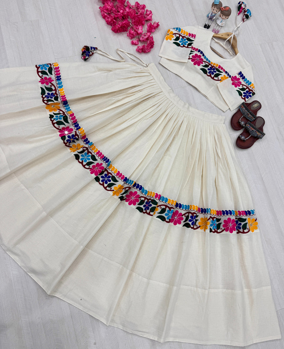 Off-white lehenga and blouse laid flat, full set