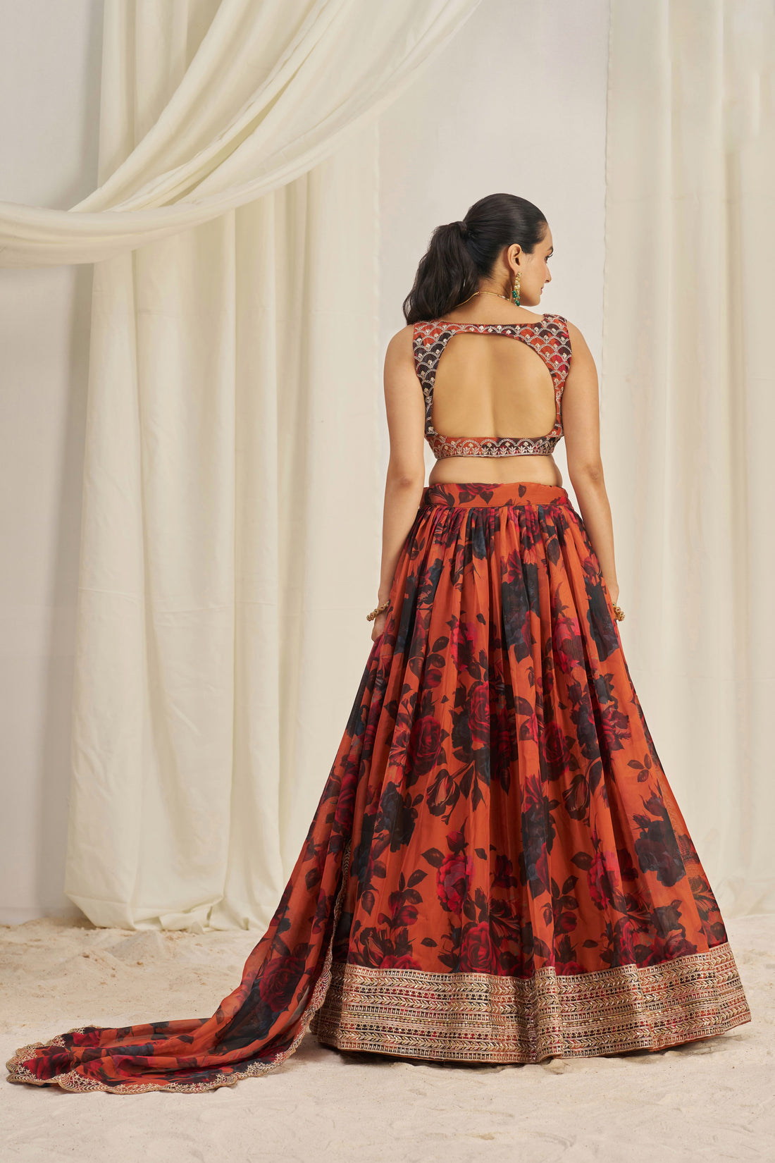Lehenga Set Features A Vibrant Orange & Black Floral Print On Organza Fabric